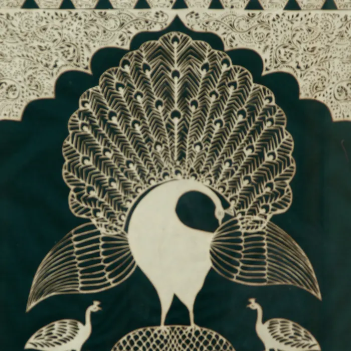 Close-up of a paper-cut peacock's tail feathers